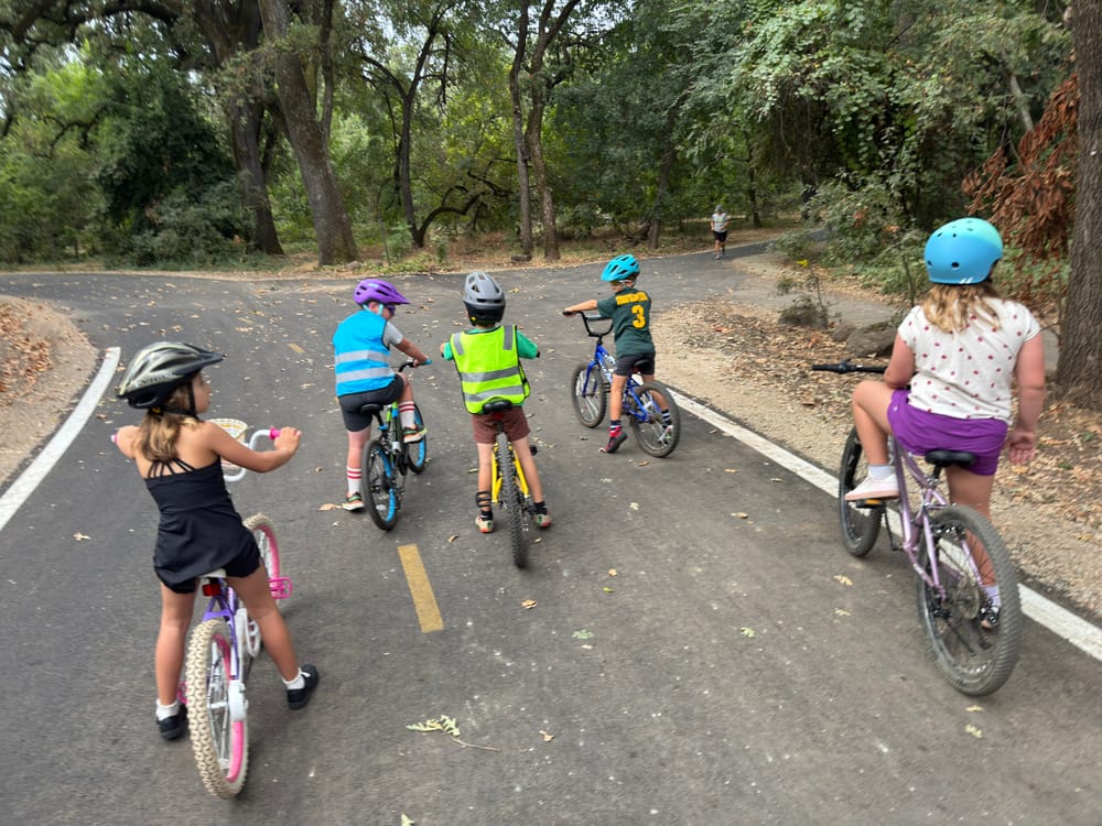 Kids and parents riding together down a Chico street
