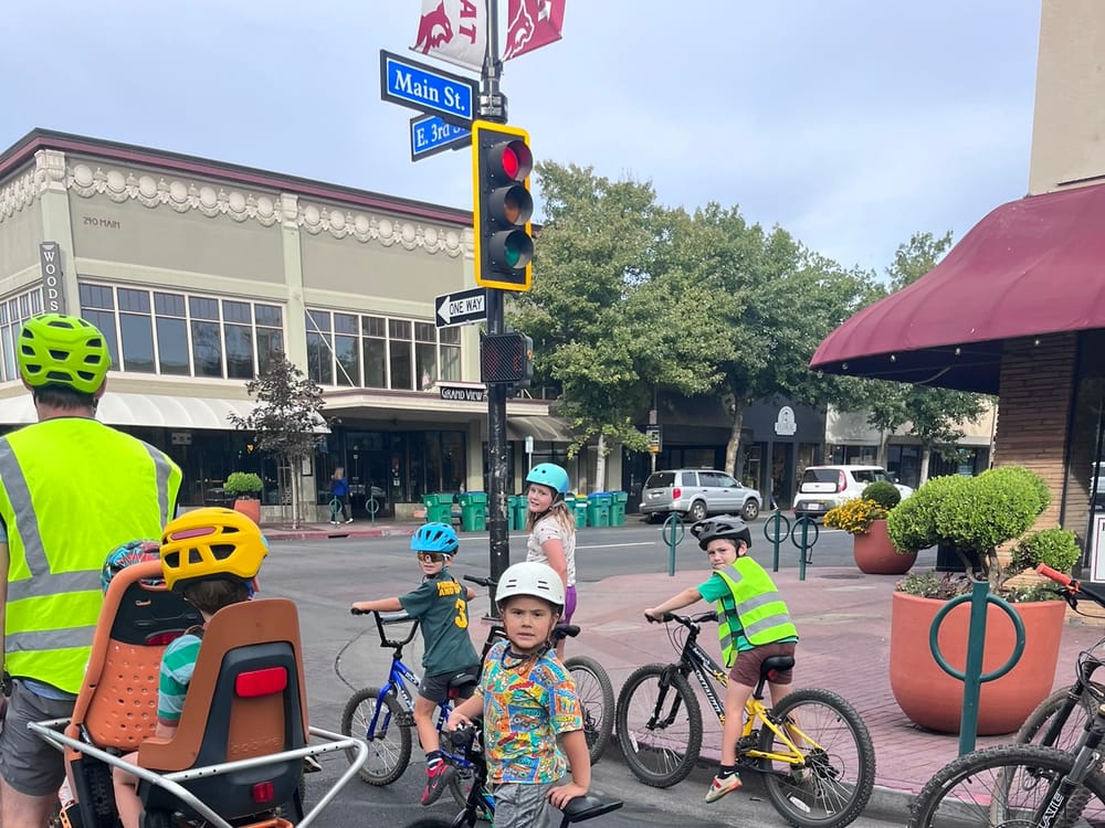A young rider smiling mid-ride with the group